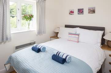 The compact bedroom has a super comfy double bed.