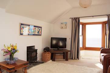 A wood-burner and sea views from the first floor sitting/dining-room.