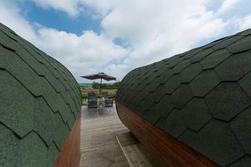 The pods sit on a large deck with a hot tub, overlooking open countryside where there is plenty of space to dine, barbecue and sunbathe.