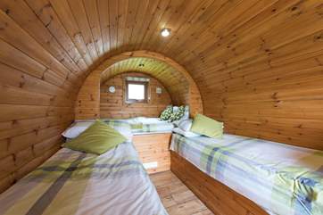 The cosy interior of the Living Pod provides you with a double bed (4' wide) and two singles (2' wide).