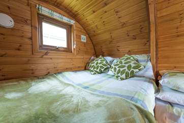The very cosy double bed is (4') wide.