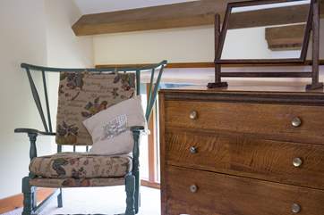 A small chair in Bedroom 1.