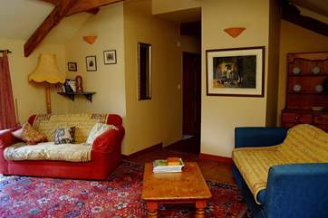 The sitting-room and door down to the bedrooms and shower-room.