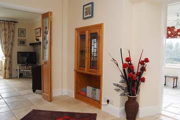 The hallway with the dining-room television to the left and the sitting-room to the right.