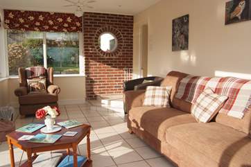 The comfortable sitting-room overlooks the garden.