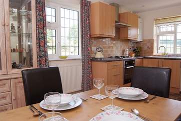 The kitchen/dining-room is lovely and bright with windows on three sides.