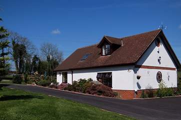 This delightful cottage is in a hilltop setting, the little patio is this side and the enclosed garden is on the far side.