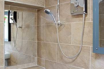 The fully tiled wet-room is next to the bedroom.
