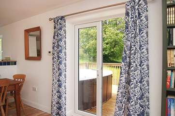 The back patio doors lead out to the deck and the hot tub.