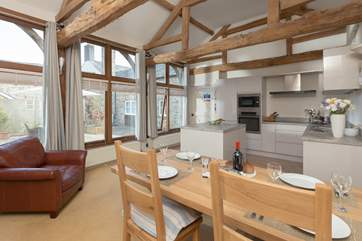 Tall windows look out into the courtyard and high beams give character to this lovely room
