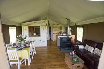 The open plan living-room includes a comfy sofa and dining table.