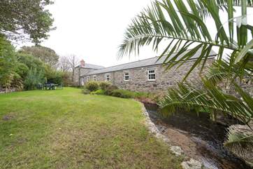 The river flows past the cottage.