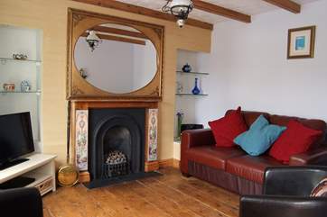 The sitting-room includes a living-flame gas fire set into the original fireplace.