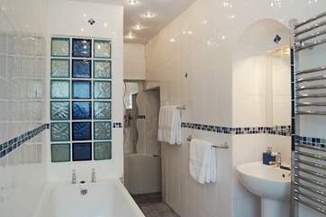 The surprisingly spacious bathroom is downstairs beyond the kitchen.