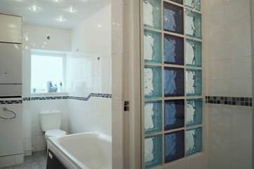 The bathroom includes a double shower cubicle as well as a bath.