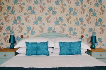 Crisp white hotel-quality bed linens complement the hand-painted bed and bedside cabinets.