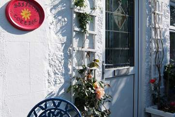There are climbing roses round the front door and in pots to either side.