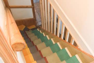 The cottage staircase has been imaginatively and colourfully painted.