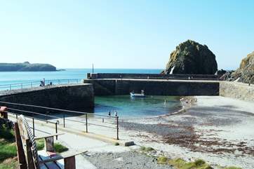 The picturesque harbour has a sandy beach at low tide.