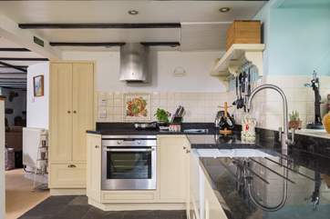 Granite worktops and a Butler sink add to the appeal of this stylish kitchen.