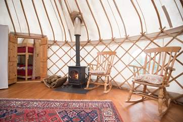 Two lovely rocking chairs next to the cosy wood-burner.