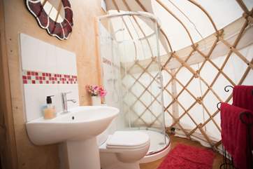 The en suite shower-area in the baby yurt has a proper hot water shower cubicle, a flushing WC and wash-basin.