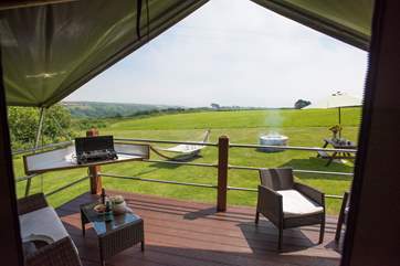Relax on the decking whilst the children enjoy the space and freedom of this glamping site.