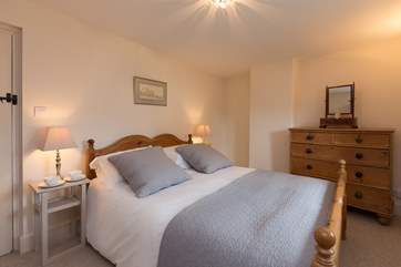 The two bedrooms are upstairs. This is the master bedroom with its king-size bed and luxurious bedding.
