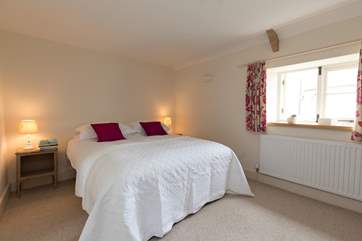 This bedroom also has a king-size bed and views over the village.