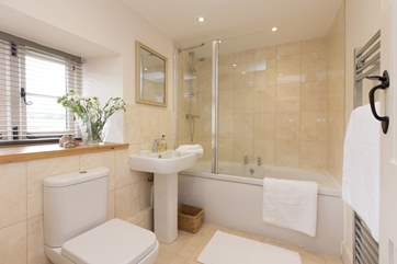 The bathroom with fitted shower over the bath, is next to the master bedroom.