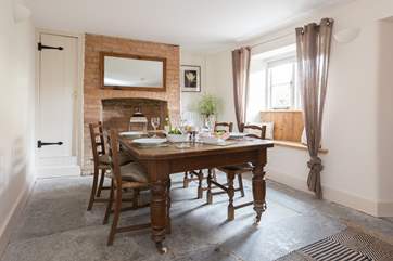 As you enter the cottage, you step into the dining-room, with its original flagstone floors and farmhouse-table.