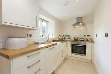 There is a very well-equipped kitchen, with a utility-room beyond it, leading out to the sheltered courtyard.
