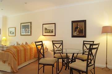 The lovely glass dining-table and wrought iron chairs are an indication of the high quality you will find in this apartment.