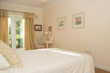 The bedroom has French doors out to a tiny deck-area overlooking the garden.