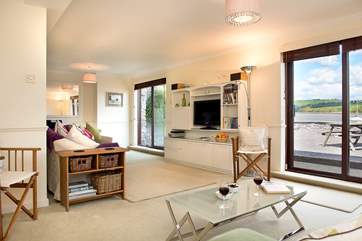 Two sets of sliding doors lead off from the sitting/dining-room to the terrace.