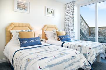 The delightful twin bedroom with sliding doors leading out to the balcony