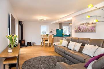 The comfy lounge area has plenty of room for everyone to chill out and relax and the toasty wood-burner makes this a perfect retreat all year round