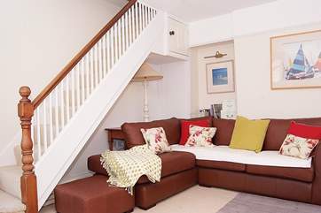 The stairs to the first floor bedrooms and bathroom run up the side of the living-room.