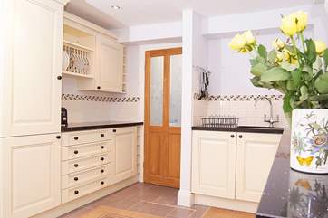 There is a really good-sized kitchen with lovely painted units, a utility-area and shower-room beyond.
