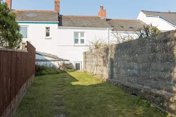 Tydemans is in fact two cottages converted skilfully into one. This is the view from the back of the fully enclosed garden. A small flight of steps lead up from the courtyard area.