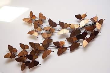 An attractive metal sculpture on the wall.
