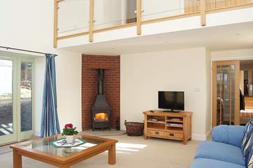 The glass-sided mezzanine level above the sitting-room can be seen in this picture.
