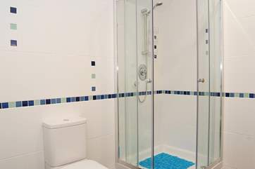 The family bathroom also has a spacious corner shower cubicle.