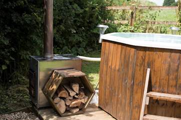 Enjoy lighting the stove and heating the water for an open-air hot tub experience. A large basket of logs can be purchased from the owner for £5.