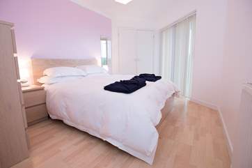 The ground floor en suite master bedroom has doors out to the decked terrace.
