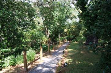 This steep but shady path leads you to the house on the river, there are a few steps at the top and bottom and half way down.