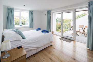 Bedroom 4 on the lower ground floor has doors out to its own patio.