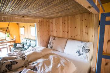 The fun double den bed has a comfortable mattress and doors that open on both sides.