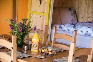 Dining table with the comfortable cabin bed in the background.