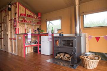 The log-fired range can be used for cooking and heating on the cooler days (logs are inclusive).